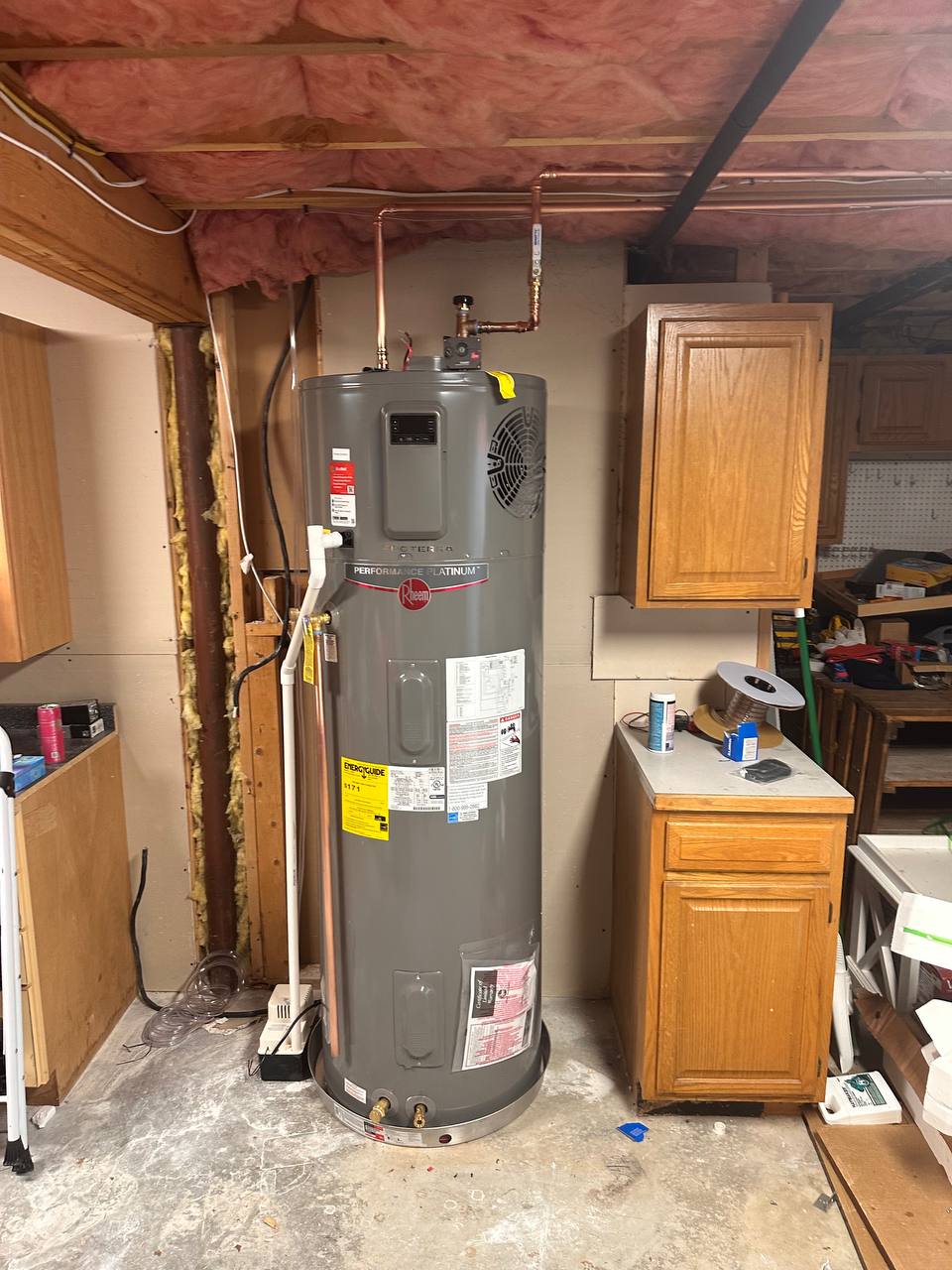 Hybrid heat pump water heater with copper supply lines in a basement utility area