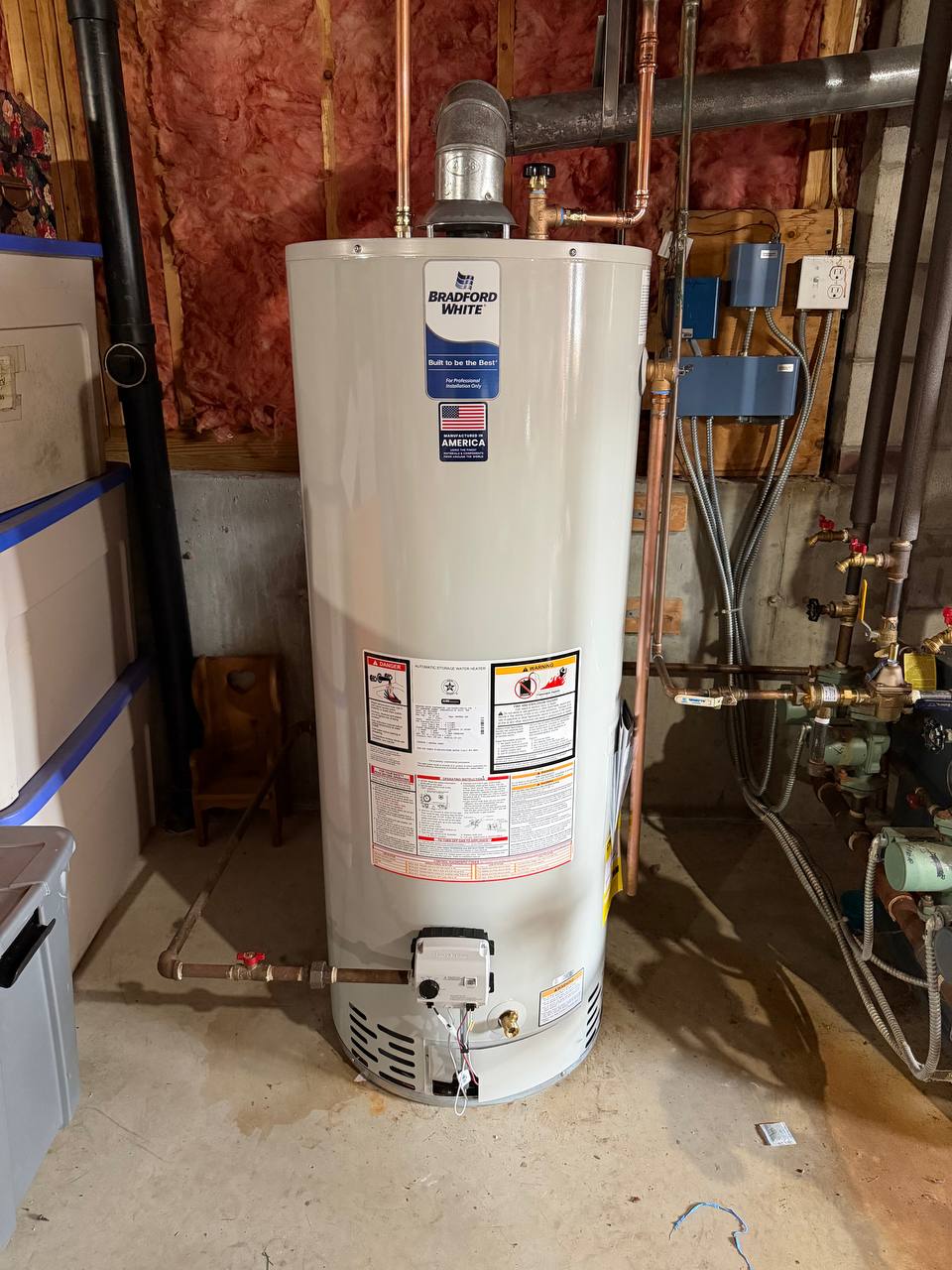 Gas water heater with galvanized flue and copper piping beside boiler piping