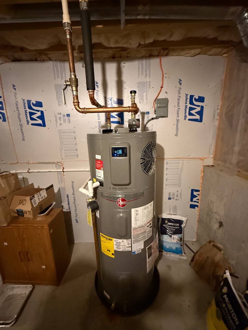 Hybrid heat pump water heater with copper piping in a basement with foam-board walls