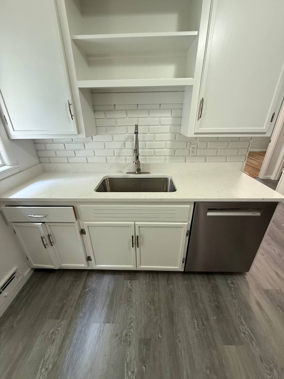 Kitchen sink with pull-down faucet, subway tile backsplash and dishwasher