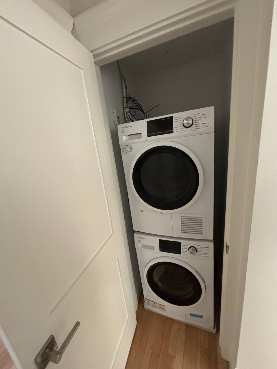 Stacked washer and dryer in a closet with water supply lines